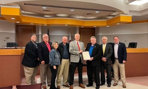 From left: Oxford City Council members Chris Spurlin, Phil Gardner and Charlotte Hubbard, Oxford City Schools board member Pat Wayne Shaddix, Dr. Jeff Goodwin, Mayor Alton Craft and council members Mike Henderson and Steven Waits.