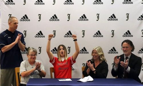 Jacksonville soccer senior Olivia King celebrates after signing her college scholarship. (Photo by Necorra Harris)