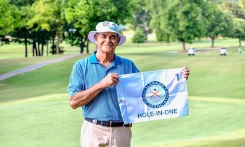 Anniston’s Chip Howell displays the commemorative pin flag presented him by the Alabama Golf Association for his hole-in-one in Friday’s round of the State Senior/Super Senior Championship.
