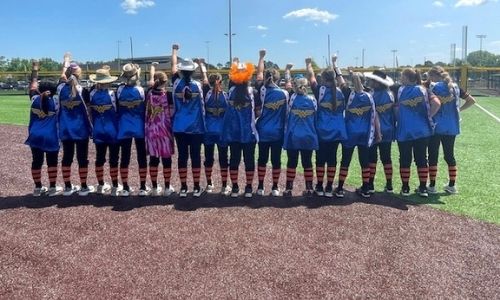 The Alexandria softball team show off the Wonder Woman rally capes they started wearing in the regionals after beating Moody for the East Central Regional title.