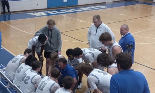 White Plains coach Chris Randall talks to his team during a timeout in the Wildcats’ victory over Cherokee County on Tuesday. (Photo by Joe Medley)