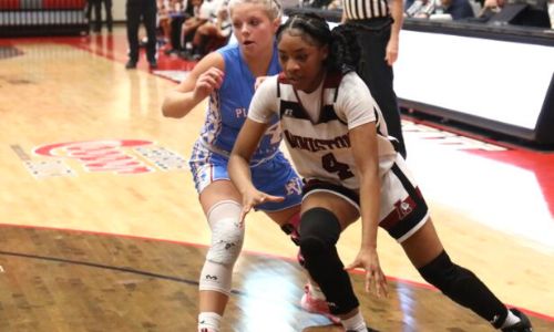 Cover photo: Anniston’s A’Kayla Perry (4) drives the basket against Pleasant Valley’s Macey Roper. (Photo by Krista Larkin)