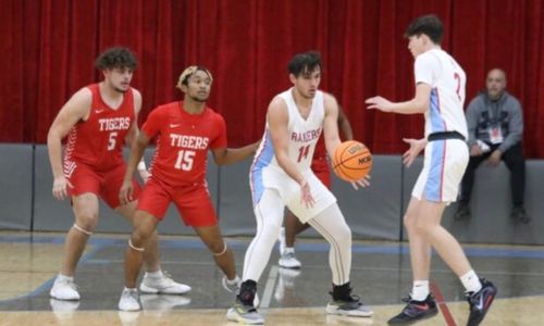 Pleasant Valley’s Kolby Battles passes Jesse Gannaway as Cedar Bluffs M.J. Adams (15) and Dylan Kinard defend. (Photo by Krista Larkin)