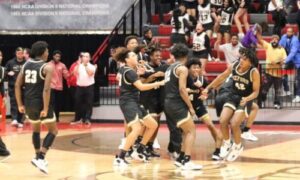 Oxford players celebrate their program’s fifth Calhoun County boys basketball title in a row and sixth in seven years Friday in Pete Mathews Coliseum. (Photo by Greg Warren)