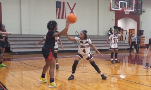 Talladega’s Makayla White passes the ball as Anniston’s A’Kayla Perry defends and Talladega teammate Houston Goins tries to post up during their Class 4A, Area 8 tournament game Monday at Handley.