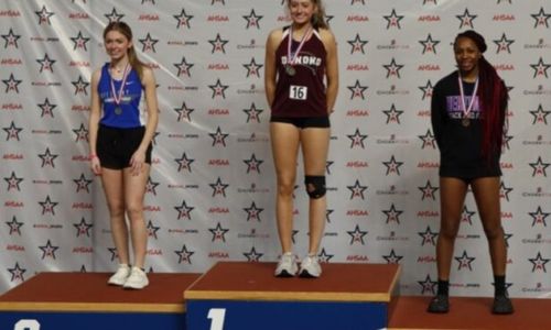 Donoho’s Estella Connell takes her place on the podium after winning a state indoor championship in the long jump Friday at Birmingham CrossPlex. (Photo submitted)