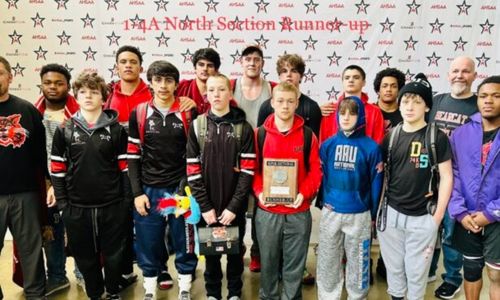 Weaver wrestlers celebrate their second-place finish at the AHSAA Class 1A-4A North Super Sectional on Saturday in Birmingham.