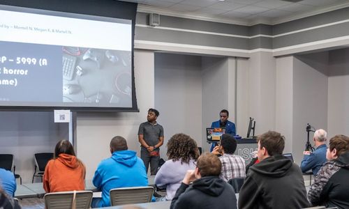 Students Martell and Montell Norman demonstrate a VR game at the 2023 Student Symposium. Photo by Alyssa Cash.