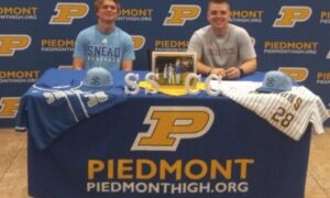Piedmont’s Max Hanson (left) and Jack Hayes celebrate their signings to play baseball with Snead State Community College on Thursday at Piedmont High School. (Photo by Joe Medley)