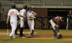 Alexandria’s Evan Snow celebrates after sliding home to complete his inside-the-park home run against Donoho in Tuesday’s Calhoun County semifinals at Choccolocco Park. (Photo by Mike Lett/lettsfocus.smugmug.com)