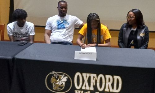 As family looks on, Oxford’s La’Mya McGrue speaks Wednesday at a celebration of her signing to play basketball for Snead State Community College. (Photo by Joe Medley)