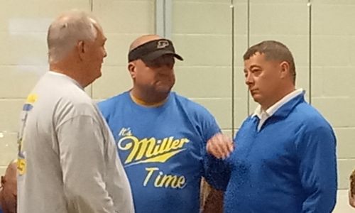 Cover photo: New Piedmont football coach and athletics director Jonathan Miller (right) talks with Scott Young (center) and the school’s athletics booster club president, Mike Pody, during Wednesday’s meet & greet in the media center. (Photo by Joe Medley)