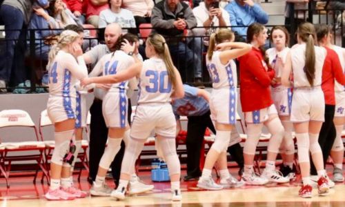 Former Pleasant Valley girls’ basketball coach Colton Morris consoles players after their loss in the Northeast Regional in February. (Photo by Greg Warren)