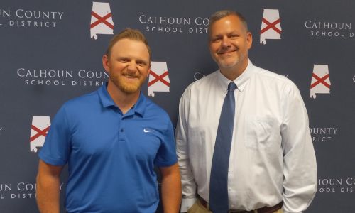 New White Plains head football coach Blake Jennings poses with Principal Andy Ward after Jennings’ hiring was approved at Thursday’s Calhoun County Board of Education meeting. (Photo by Joe Medley)