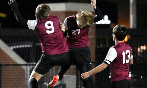 Donoho’s Bruce Downey (27), Trey Alexander (9) and Logan Melton celebrate during their 2-1 victory over Oxford in Saturday’s Isaac Crook Invitational final on Oxford’s Lamar Field. (Photo by B.J. Franklin/gunghophotos.com)