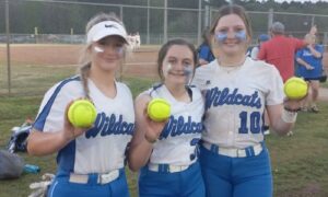 White Plains’ Haylie Smith (left), Karli Otwell (center) and Leighton Arnold show off their home-run balls after the Wildcats rallied from a 6-0 deficit to beat Pleasant Valley 7-6 in Tuesday’s Calhoun County tournament action at Woodland Park. (Photo by Joe Medley)