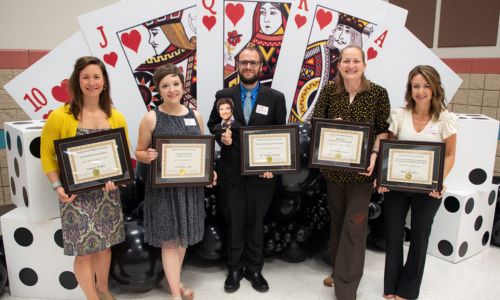 The 2023 Distinguished Faculty Award winners include, from left: Katelyn Walker, Dr. Allegra Smith, Dr. Mark Sciuchetti holding a photo of Dr. Cynthia McCarty, Dr. Ashley Turner and Aimee Weathers. Not pictured: Diane Chong. Photo by Austin Tillison.