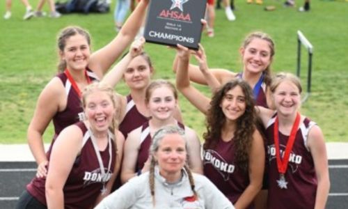 Hayley Long poses with the Donoho girls’ track team after they won their sectional in 2022. (Submitted photo)
