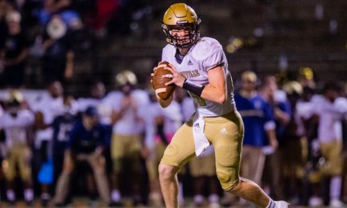 Jacksonville quarterback Jim Ogle rolls out against Cleburne County in 2021. (Photo by Jonathan Fordham)