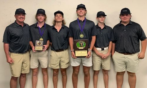 White Plains coach Chris Randall (left) and his team show off their hardware after winning the Chesley Oaks Invitational on Tuesday at Holly Pond. (Submitted photo)