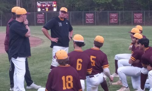 Donoho coach Steve Gendron has a light-hearted postgame talk with his team after the Falcons rallied from a 10-run deficit to beat Pleasant Valley 12-10 on Tuesday. (Photo by Joe Medley)