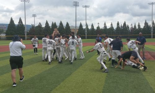 Oxford players charge the field to get the AHSAA’s ‘blue map’ state championship trophy after beating Spanish Fort 12-3 in Game 2 of their Class 6A state-title series Wednesday on Rudy Abbott Field. (Photo by Joe Medley)