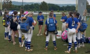 Tiffany Williams talks to White Plains’ softball team after the Wildcats completed play in the state tournament Friday at Choccolocco Park. (Photo by Joe Medley)