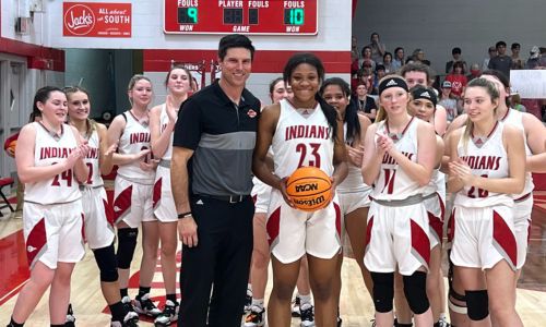 Former Ohatchee girls’ and boys’ basketball coach Bryant Ginn celebrates a career milestone with Jorda Crook this past season. Ginn, an Alexandria graduate whose children attend Alexandria, is leaving Ohatchee to join Alexandria’s staff. (File photo)