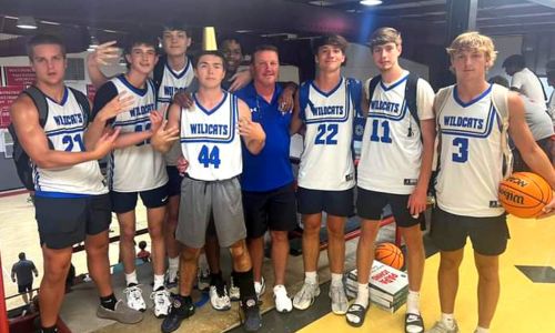 White Plains boys’ basketball coach Chris Randall (center) and his top varsity players celebrate after winning the ‘Cardiac Tournament’ during Wednesday night play in Coach T Hoops Team Basketball Camp at Bryan College, in Dayton, Tenn. (Submitted photo)