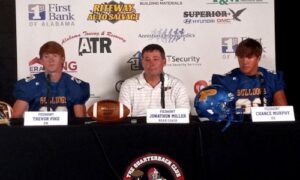 First-year Piedmont coach Jonathan Miller (center) sits between players Chance Murphy and Trevor Pike at Friday’s Calhoun County Quarterback Club Media Day at Anniston Country Club. (Photo by Joe Medley)