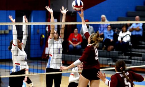 Pleasant Valley’s Madison Schwabe (4) and Ellie Patterson go up to block as Donoho’s Estella Connell hits during Tuesday’s Class 2A, Area 12 final at Pleasant Valley. (Photo by Krista Larkin/For East Alabama Sports Today)