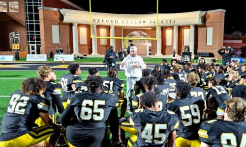 Oxford coach Sam Adams talks to his team after the Yellow Jackets beat Center Point on Lamar Field on Friday. (Photo by Joe Medley)