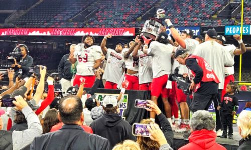 Jax State senior football players hoist the R+L Carriers New Orleans Bowl trophy after beating Louisiana 34-31 in overtime Saturday in the Caesers Superdome. (Photo by Joe Medley)