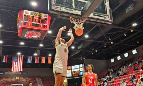 Oxford’s Jaylen Alexander finishes off a dunk against Saks in Calhoun County quarterfinal action Thursday in Pete Mathews Coliseum. (Photo by Joe Medley)