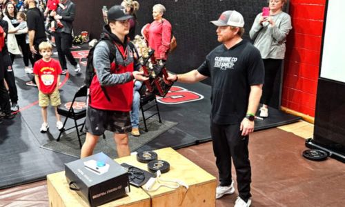 Weaver’s Hunter Hise collects the Bearcats’ trophy for winning Saturday’s Rumble in the Jungle at Cleburne County. Cleburne County, Piedmont, Ranburne and Weaver will wrestle in the Class 1A-4A state duals quarterfinals Friday. (Photo by Joe Medley)