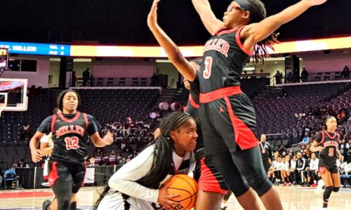Anniston’s Tykeria Smith tries to get a shot up against T.R. Miller during their Class 4A state semifinal Tuesday in Birmingham’s Legacy Arena. (Photo by Joe Medley)