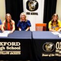 Oxford’s Ashlyn Burns (left) and Berkley Mooney celebrated their college signings at Monday’s ceremony in the Oxford High School media center. Burns will play for Wallace State Community College and Mooney for the University of Montevallo. (Photo by Joe Medley)