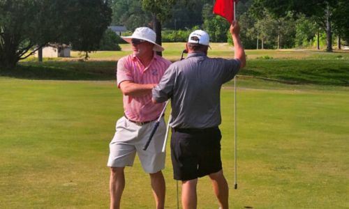 Ty Cole shakes hands with runner up Chad Calvert on Sunday after winning the Anniston City Championship at Cane Creek. (Photo by Joe Medley)