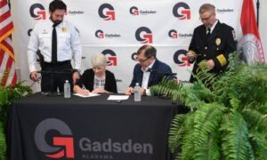 Gadsden State Community College president Dr. Kathy Murphy signs a Memorandum of Understanding between the College’s and City of Gadsden’s police departments as GSCC police chief Jay Freeman stands behind her. City of Gadsden mayor Craig Ford and Gadsden Police Department chief Lamar Jaggears wait to sign.