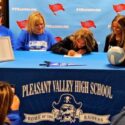 With retiring Pleasant Valley volleyball coach Dana Bryant looking on, Maddie Schwabe signs Friday to play for Calhoun Community College. (Photo Joe Medley)
