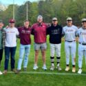 Current and former Donoho players celebrate the Falcons’ 10th season under head coach Steve Gendron (black hoodie) after Donoho beat Gaston 7-5 on Wednesday. (Submitted photo)