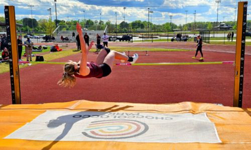Donoho’s Estella Connell jumps to victory in the Calhoun County meet April 3 at Choccolocco Park. She qualified for the state meet in four events, with first-place finishes in three at sectional. (Photo by Joe Medley)