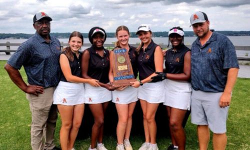 Flanked by assistant coach Brenard Howard (left) and head coach Craig Kiker, Alexandria’s girls’ golf team poses with the state-championship trophy they won over Monday and Tuesday at RTJ-The Shoals. (Submitted photo)