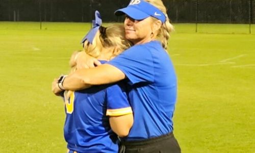 Rachel Smith and daughter Savannah Smith embrace at Choccolocco Park after the final game of Piedmont’s most recent state-tournament run. (Photo by Joe Medley)