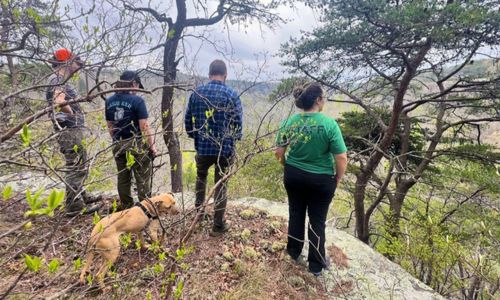 Fresh Water Land Trust staff and JSU Field School Asst. Director Rebekah Taylor inspect the view from the acquired property on the East Rim of Little River Canyon. Photo Courtesy of JSU