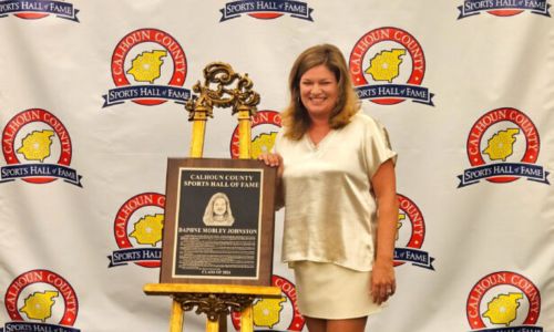 Former Donoho volleyball and basketball standout Daphne Mobley Johnston poses with her Calhoun County Sports Hall of Fame plaque before Saturday’s induction ceremony at the Oxford Civic Center. (Photo by Joe Medley)