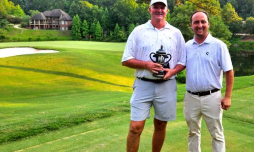 Gary Wigington (left) and Cider Ridge Golf Course owner and president Cory Etter pose with the trophy Sunday, after Wigington won the 2024 Oxford City Championship. (Photo by Joe Medley)