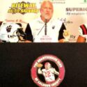 Second-year Weaver coach Ken Cofer, flanked by KeShawn Allen (left) and Kaden Gooden, talks during Calhoun County Quarterback Club Media Day in July. (Photo by Joe Medley)