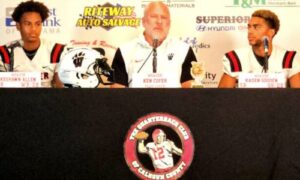 Second-year Weaver coach Ken Cofer, flanked by KeShawn Allen (left) and Kaden Gooden, talks during Calhoun County Quarterback Club Media Day in July. (Photo by Joe Medley)