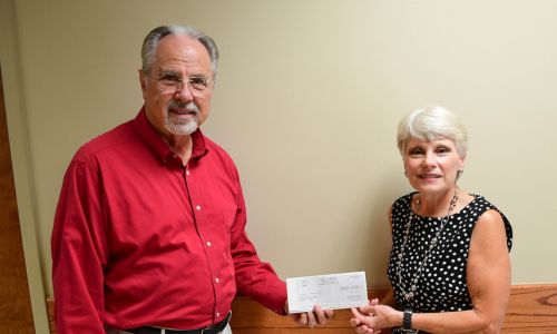 Rep. Mark Gidley presents donation check to President Kathy Murphy for Gadsden State scholarships.